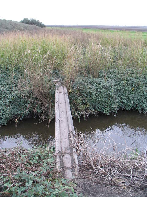 Narrow bridge across drainage ditch