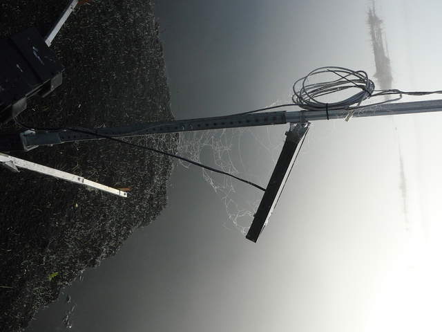 Dew on spider webs on camera solar panel