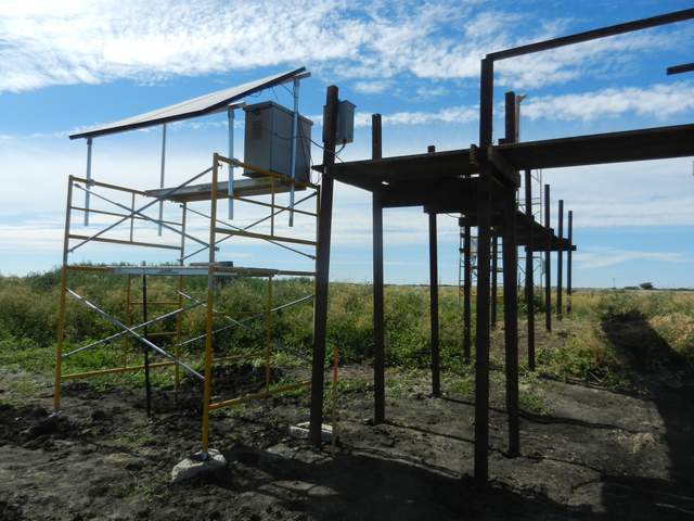 Upgraded solar scaffolding at Sherman wetland, now with concrete blocks under the scaffolding feet