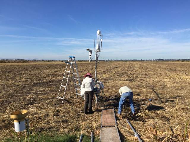 Eddy covariance and meteorological sensors on a tripod in a disked, dry field. Elke and Dennis are working on reinstalling the sensors.