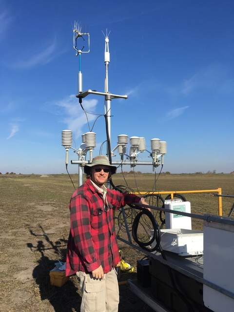 Joe with 9 out of 12 AirT/RH sensors set up for testing. The last three sensor will go on the post supporting the flux sensors.