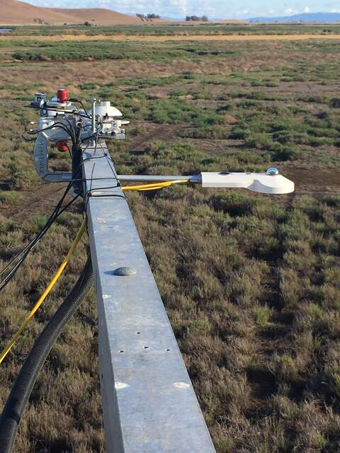 Radiometer calibration kit installed on Hill Slough rad boom (4-way radiometer, Apogee NDVI pair, PAR). Note high winds blowing the loose cables sideways.