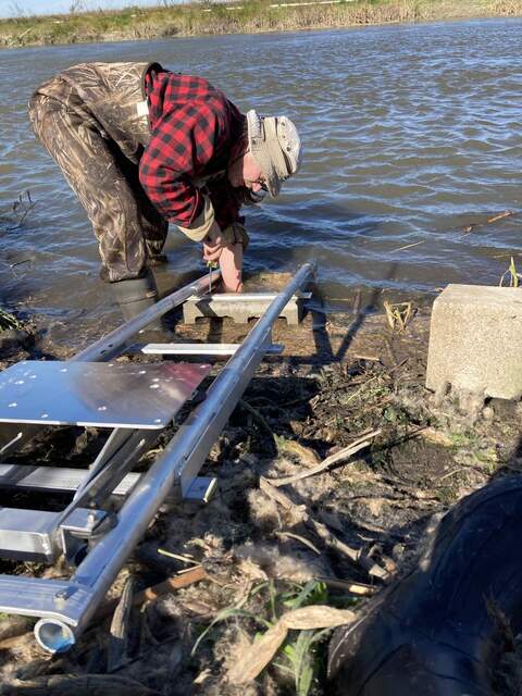 Joe installing track for Acoustic Doppler Current Profiler at Gilbert Track breech