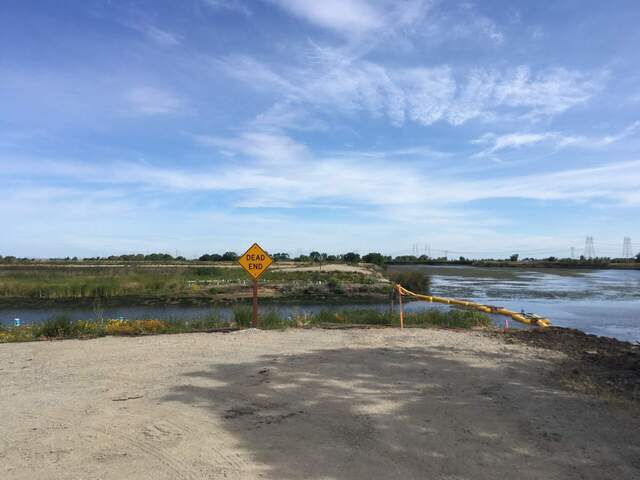 New sign at the breach site. I suppose that it could possibly help prevent people from driving off the road