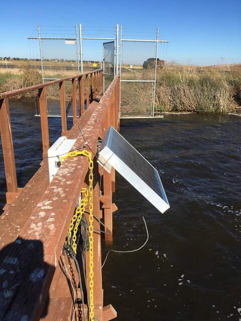 Small solar panel and CR23X installed on railing at channel. The CR23X is collecting data from a dissolved CO2 probe (eosGP) and a conductivity-temperature-depth probe (HYDROS21).