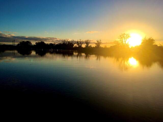 Sunrise at little Dutch Slough breach, photo view is downstream, facing the booms at the channel mouth