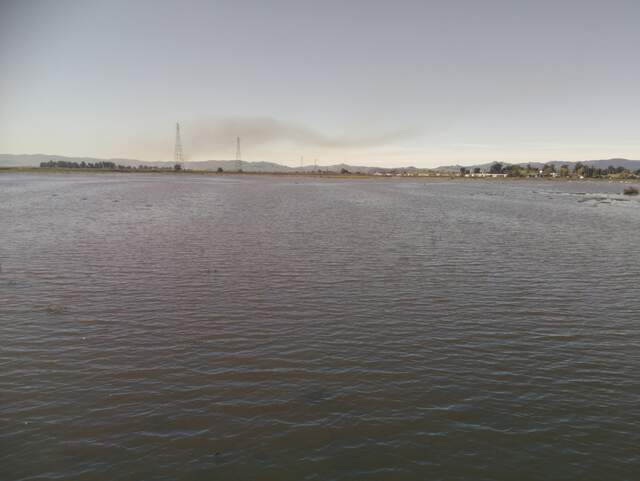 Smoke plume at high tide