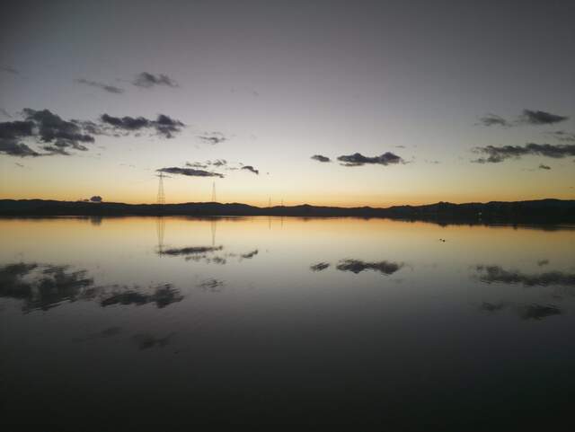 Clouds reflected in water after sunset