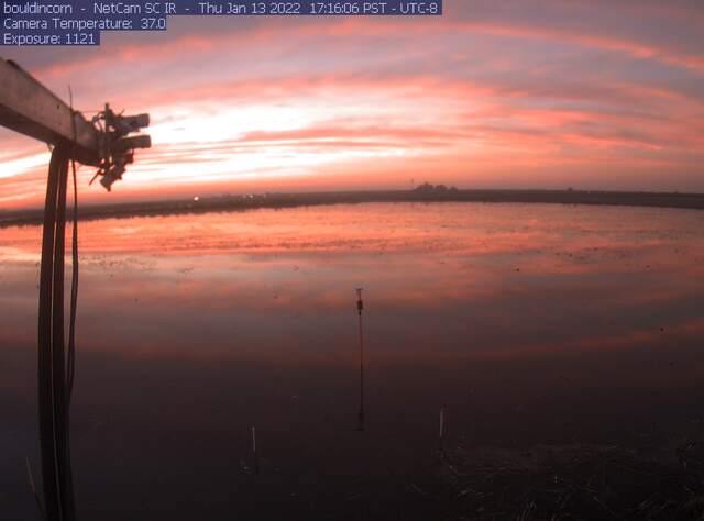 Beautiful sunset reflected in flooded field