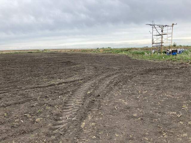 Our field has been tilled. Tractors working on nearby fields.