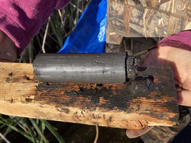 Test soil core from PCV pipe in ankle deep water