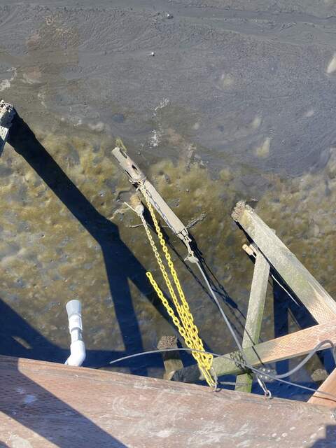 Water sensors half buried in the mud at low tide