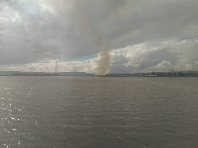 Smoke plume to the west over the water